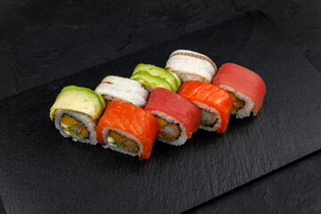 Japanese cuisine. Rolls on a dark concrete background
