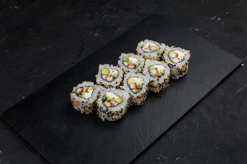 Japanese cuisine. Rolls on a dark concrete background
