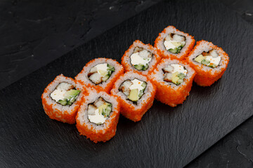 Japanese cuisine. Rolls on a dark concrete background
