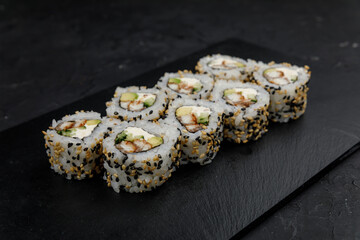 Japanese cuisine. Rolls on a dark concrete background
