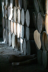 wooden barrels stacked in old abandoned industry building