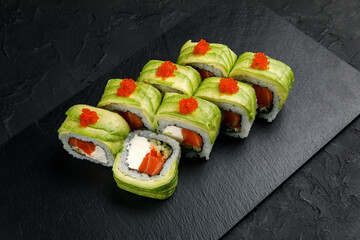 Japanese cuisine. Rolls on a dark concrete background

