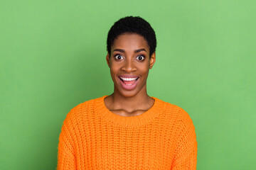 Photo of impressed millennial short hairdo lady wear orange sweater isolated on green color background - Powered by Adobe
