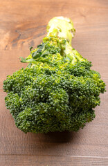 Raw fresh broccoli on old wooden table.
