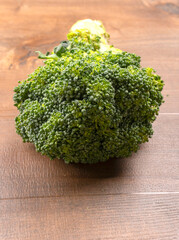 Raw fresh broccoli on old wooden table.

