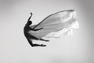 Black and white portrait of graceful ballerina dancing with fabric, cloth isolated on grey studio background. Grace, art, beauty concept. Weightless, flexible.