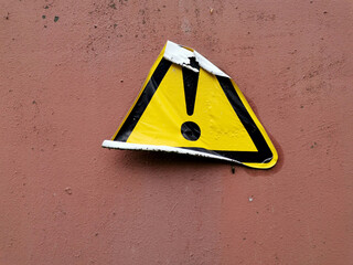 sticker of a sign of attention on a metal door or panel