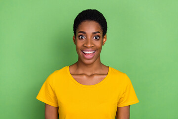 Photo of impressed millennial short hairdo lady wear yellow t-shirt isolated on green color background
