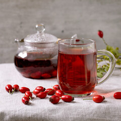 Rose hip berries herbal tea in glass teapot - 497080734