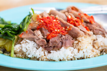 Thai food menu: pork leg rice Topped with chili and orange juice,Eat with kale, pickled cabbage, garlic and fresh chili.
