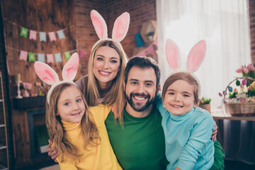 Portrait of attractive cheerful idyllic family having fun easter domestic party event wear hare costume indoors