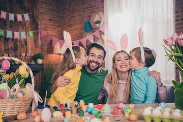 Portrait of attractive funny adorable full big cheerful family parents having fun coloring eggs...