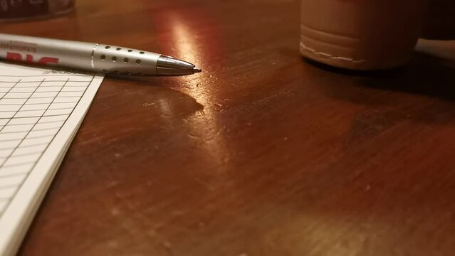 Cup of dice being turned over onto a table during a board game. Static close up shot 