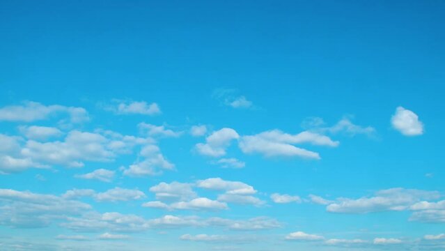 Calm background with sky and white, slowly moving clouds. A simple blue background on the theme of nature, weather and peaceful enlightenment.