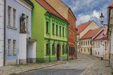 Fototapeta na wymiar Bratislava, Slovakia Kapitulska picturesque Old Town medieval street with traditional low-rise houses and cobblestone road without crowd.