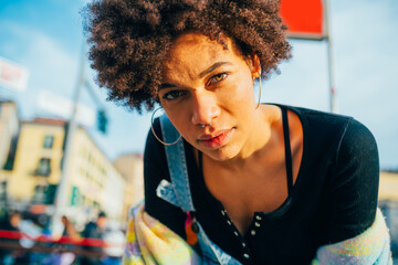 Portrait confident young black woman posing outdoor independent