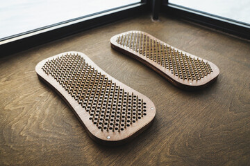 Sadhu board with nails on the wooden floor close-up. Health concept