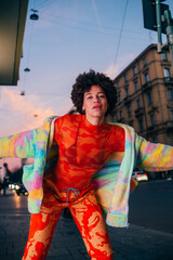 Fototapeta premium Young black curly hair dancer fashionable stylish performer dancing outdoor