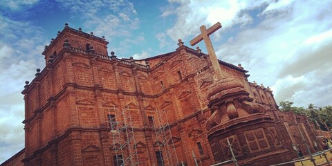 magnificent church cathedral cross under blue sky with clouds