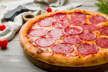 Pepperoni pizza on grey wooden table macro close up