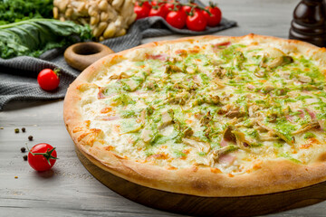 pizza with bacon and oyster mushrooms on grey wooden table macro close up