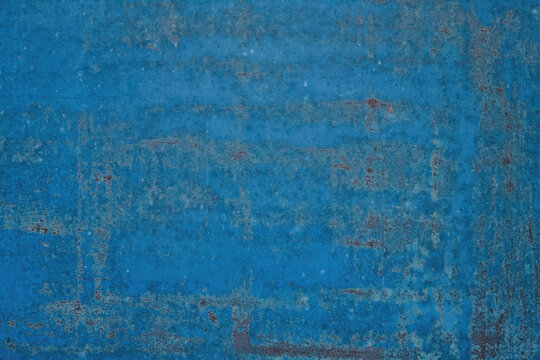 Old shabby painted blue metal surface background.