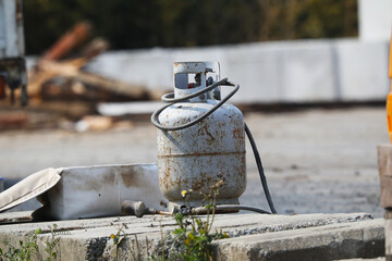 Old propane gas randomly placed on an outdoor work site