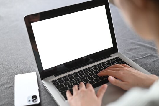 mockup image blank screen computer with white background for advertising text, hand woman using laptop contact business search information on desk at home.marketing and creative design