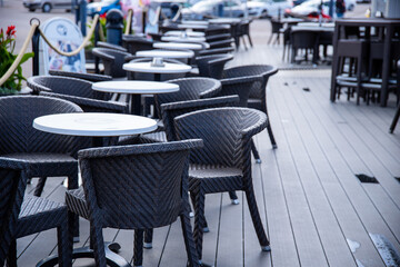 tables and chairs in a restaurant at outdoors. empty terace.