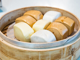 Mantou, a Chinese Steamed Buns dessert isolated in bamboo steamer