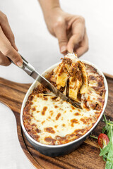 fresh beef lasagna in oven dish on table in rome italy restaurant