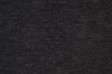 Fototapeta na wymiar Black knitted fabric cotton textured background. Closeup with copy space for your design