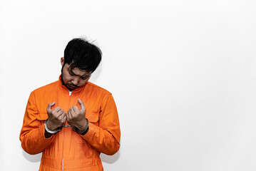 Prisoner in orange robe concept,Portrait of asian handsome man in Prison uniforms,Bandit has a lot...