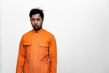 Prisoner in orange robe concept,Portrait of asian handsome man in Prison uniforms,Bandit has a lot of muscle,