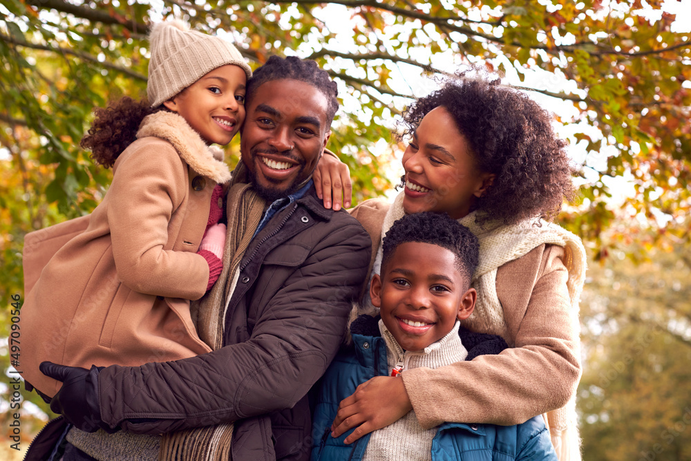 Wall mural Portrait Of Smiling Family On Walk Through Countryside Against Autumn Trees