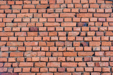 Fototapeta premium Red brick wall texture grunge background with vignetted corners to interior design