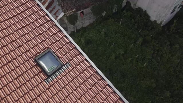 Birds flying over a velux window in a renovated roof top