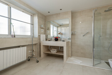 Bathroom with glass sliding door shower stall, porcelain hanging sink, integrated frameless mirror with light