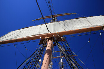 Blue sky sailing boat mast
