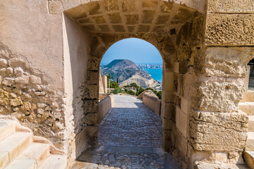 A view through an arch in the castle of Saint Ferran above Alicante on a spring day