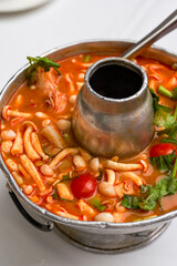 A pot of hot and sour Thai Tom Yum soup
