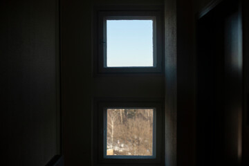 Fototapeta na wymiar Two windows. Window opening inside house. Different view through glass.