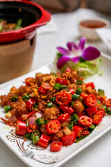 A plate of spicy and crispy fried chicken with crispy double peppers