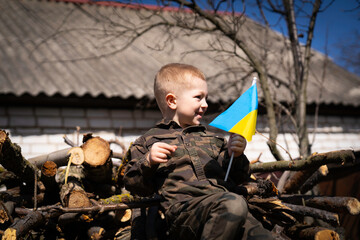 The child holds the flag of Ukraine in his hands. Hope for the world. Save Ukraine