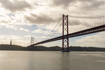 Fototapeta na wymiar 25th of April bridge and Christ the King statue, in Lisbon - Portugal