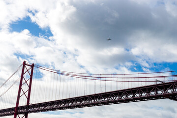April 25th Bridge with an airplane in the sky, in Lisbon - Portugal