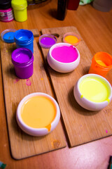 palette with blue, red, pink paint on a wooden base