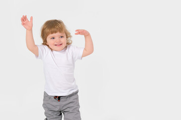 Cheerful beautiful child with blond hair on a white background. Copy space . High quality photo