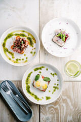 Smorrebrods, Danish open sandwich with salmon, egg, roast beef sweet onions, herring, onion, avocado and cilantro sauce.