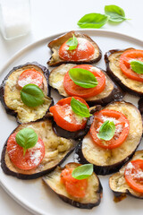 Baked eggplant with tomato, cheese and basil